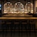 A lighted bar with stools, tables, chairs and hundreds of Jameson Irish Whiskey products